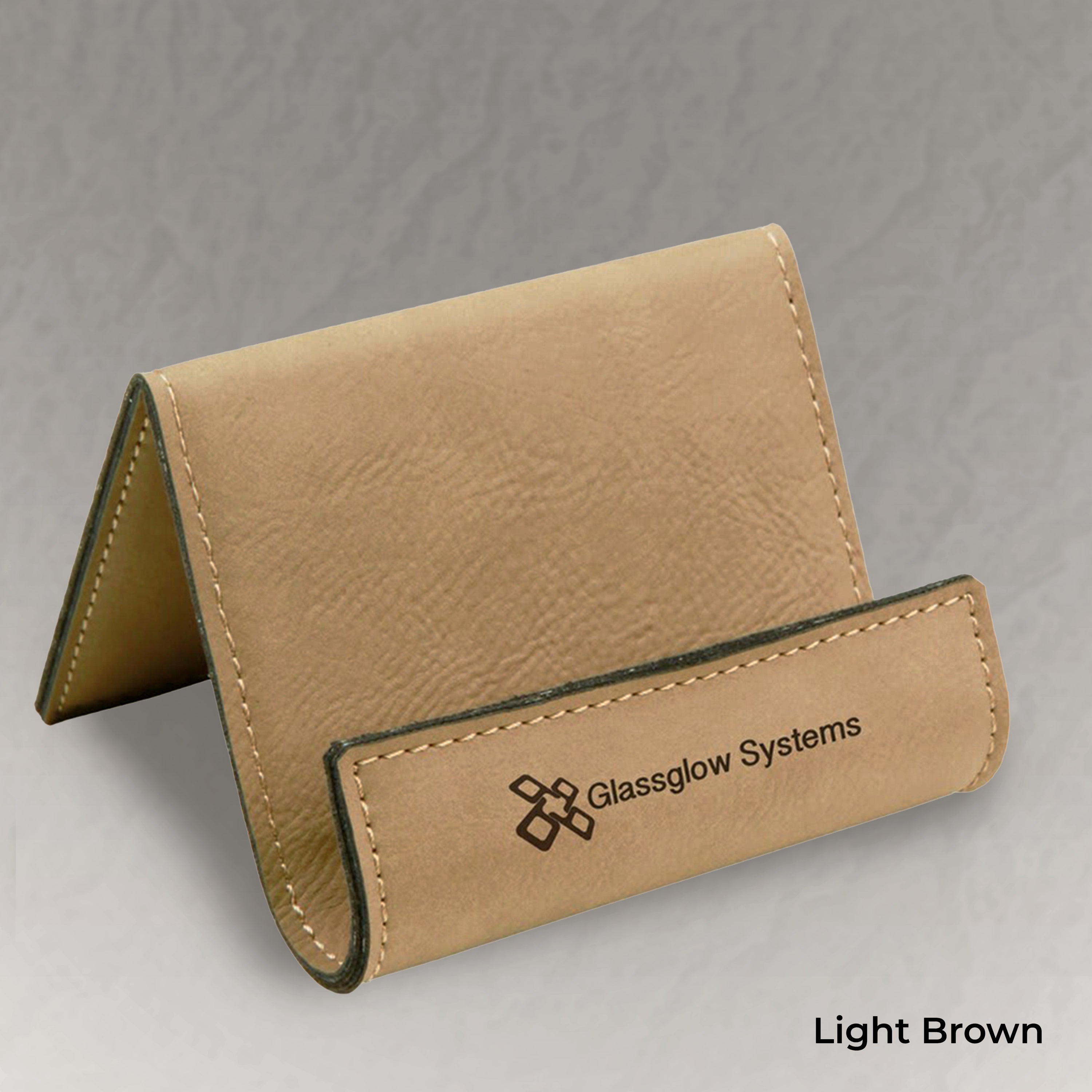 Light brown leather business card holder with 'Glassglow Systems' branding on a gray background