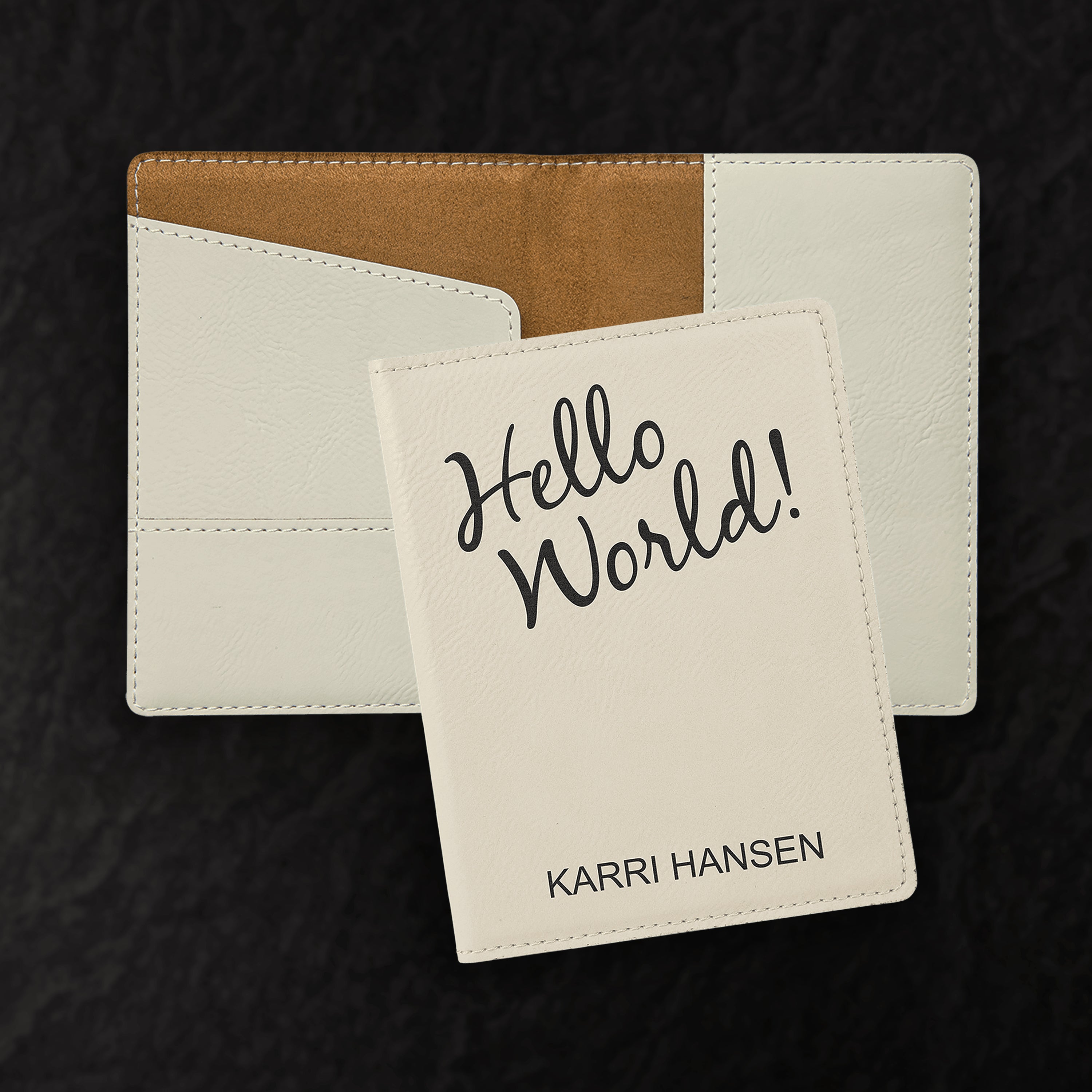 Two cardholders with one displaying 'Hello World!' text and brand name on a dark background