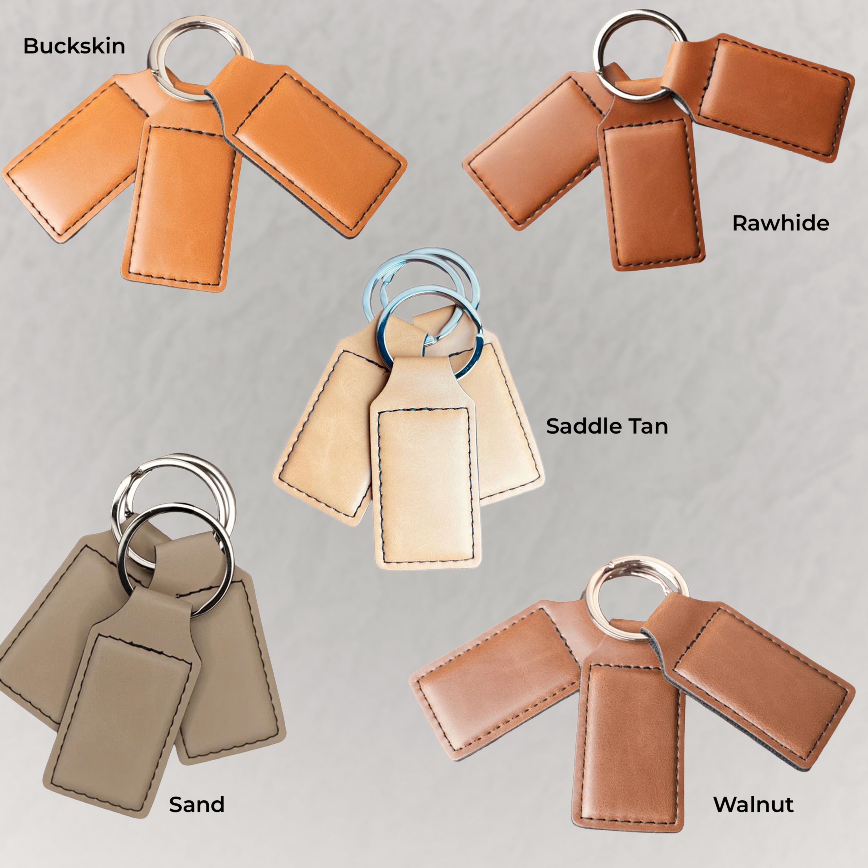 Set of leather keychains in different colors on a gray background