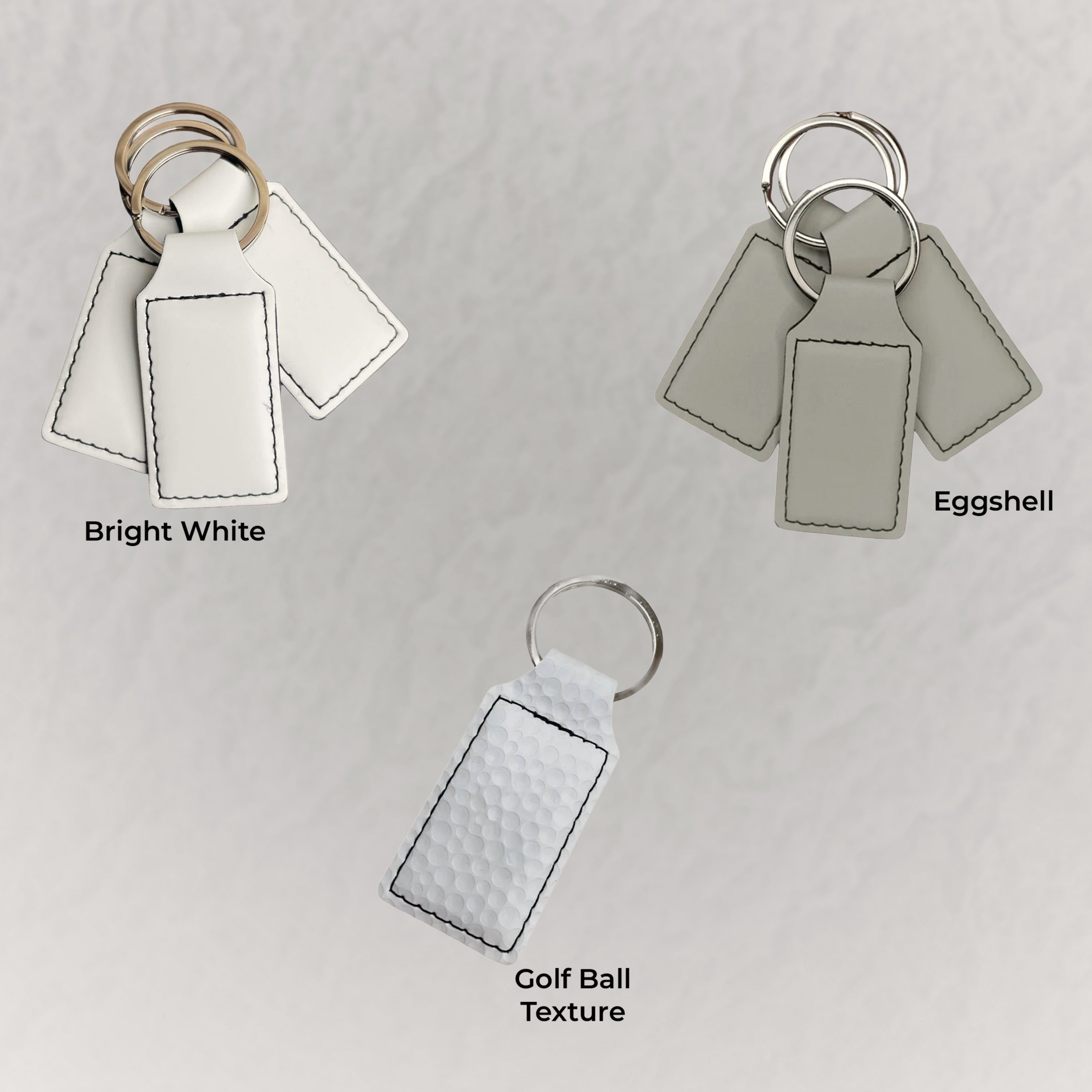 Three keychains with different color options on a light gray background