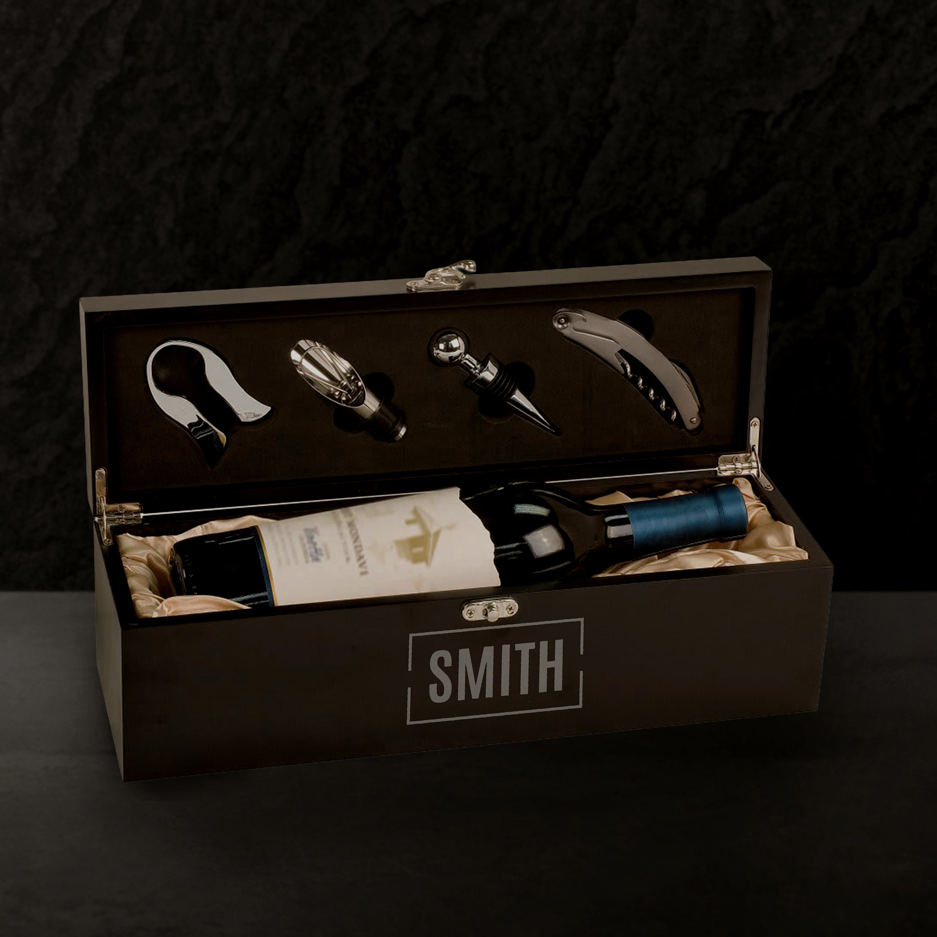Wine set with bottle, accessories, and 'SMITH' branding in a box against a dark background