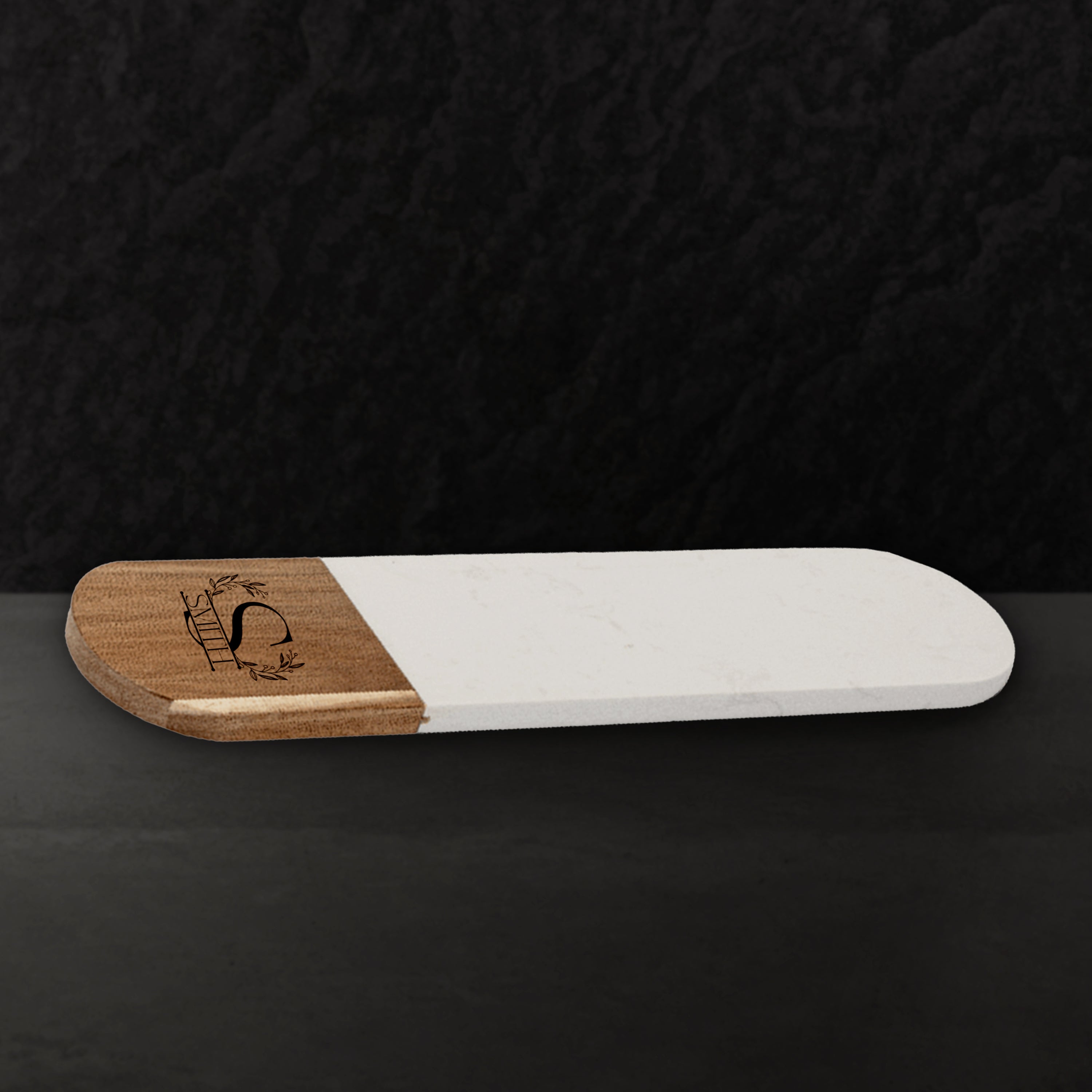 Two-tone wooden and white serving board on a black background