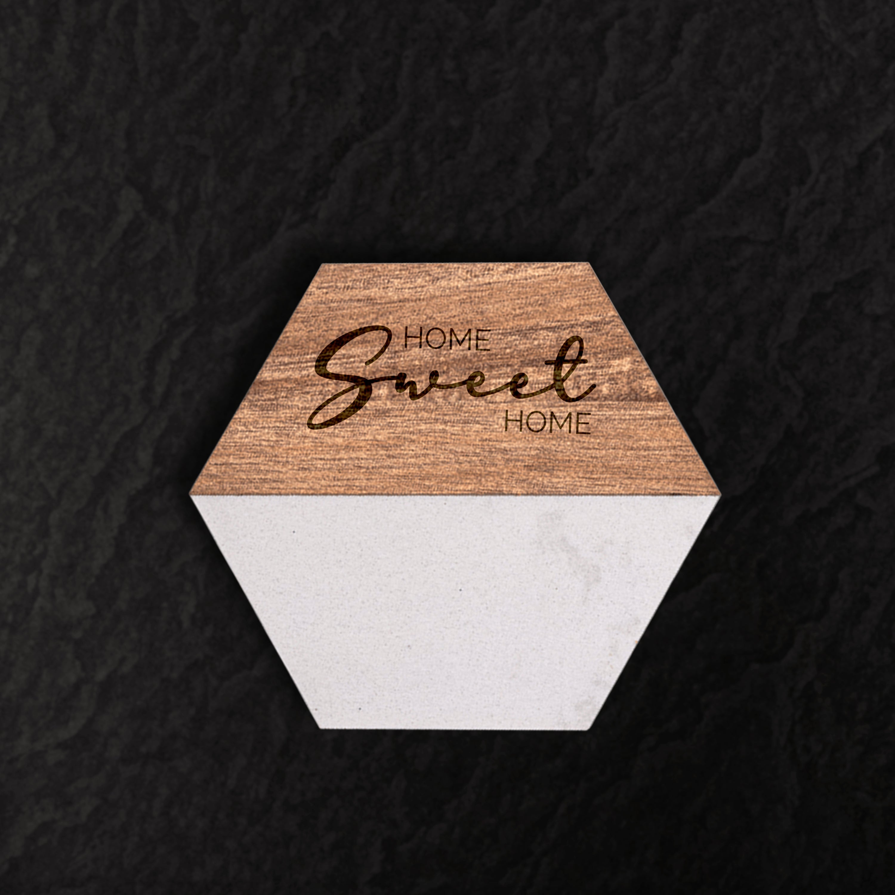 Hexagonal coaster with 'Home Sweet Home' text on a dark textured background