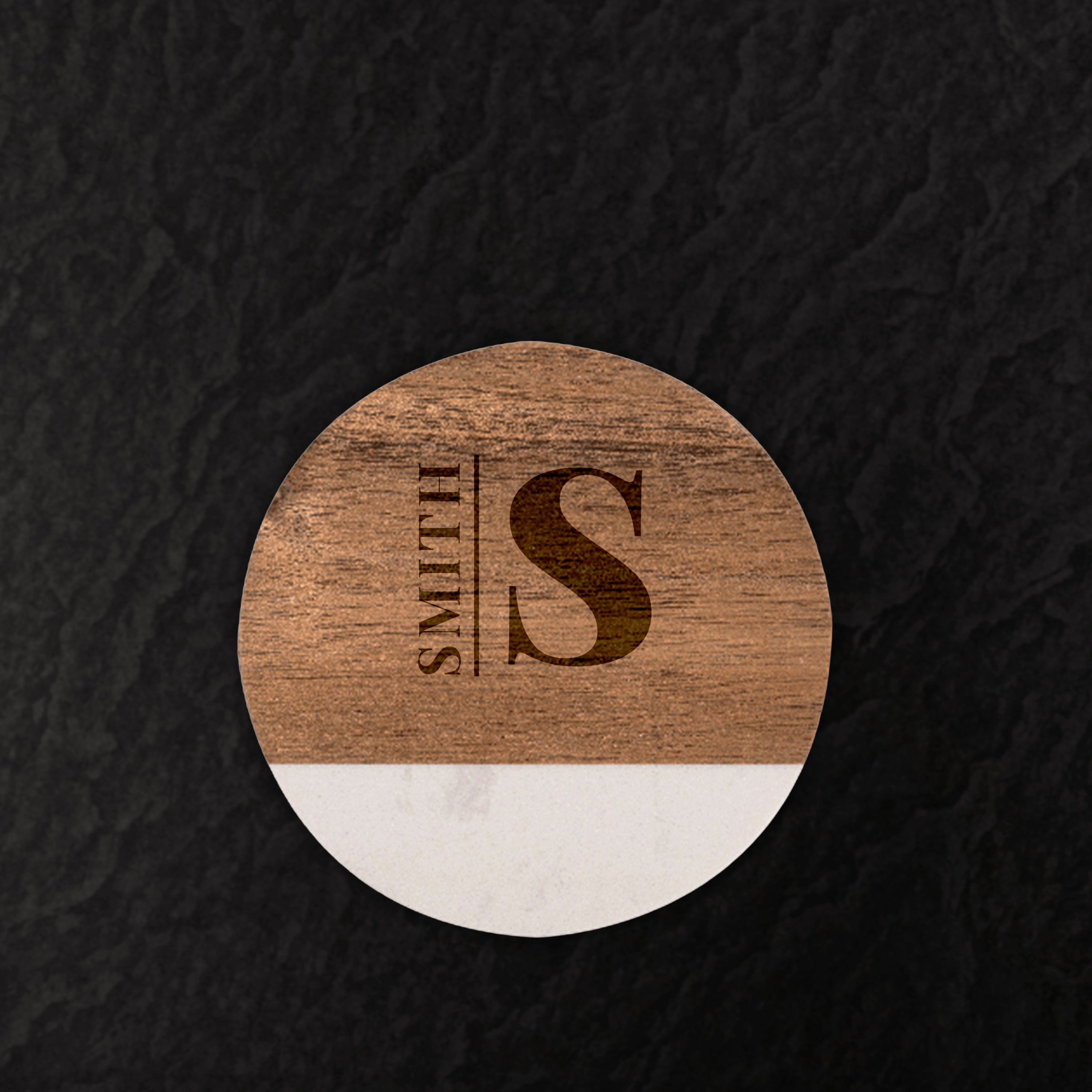 Wooden coaster with 'Smith S' engraving on a dark textured background