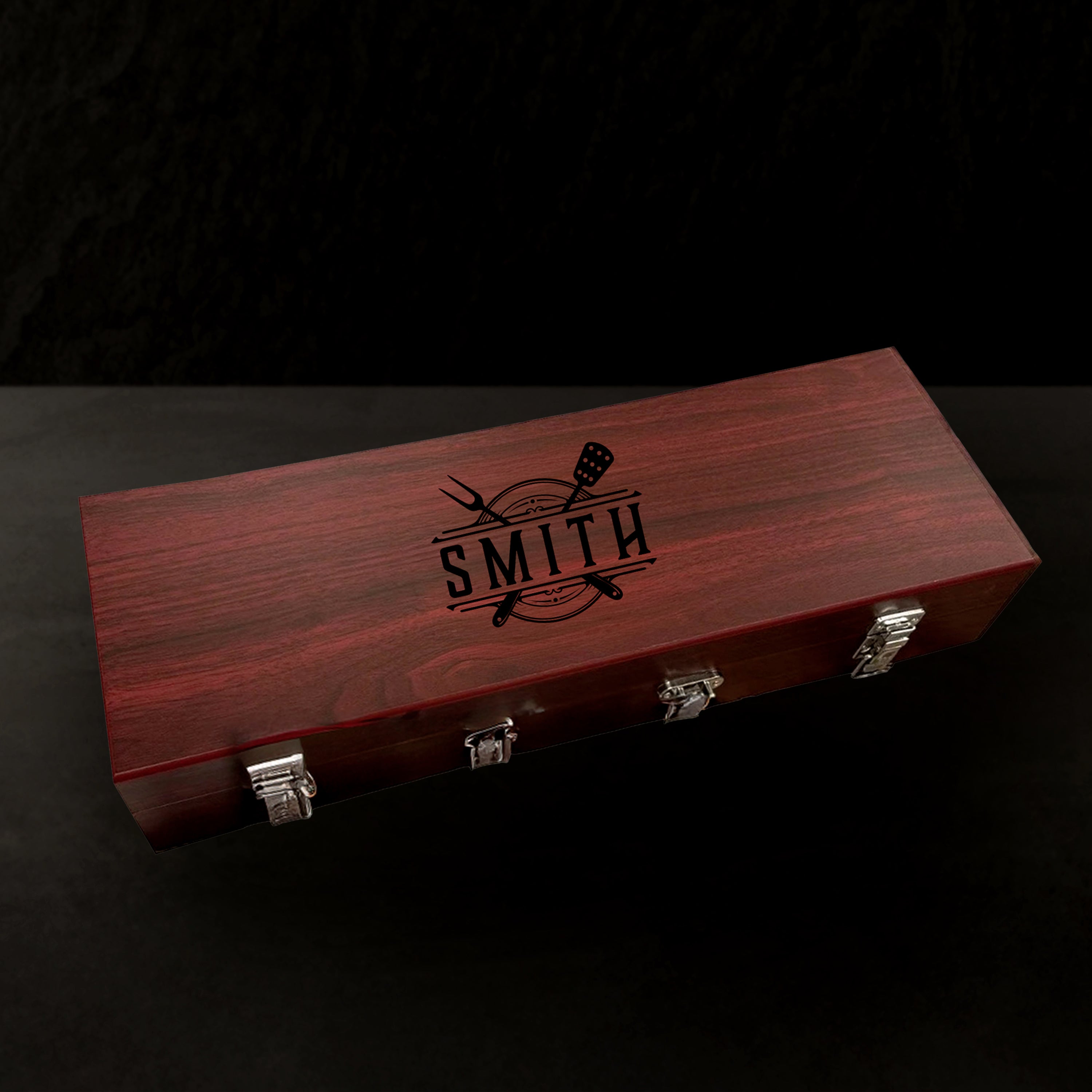 Wooden box with 'Smith' engraving on a black background
