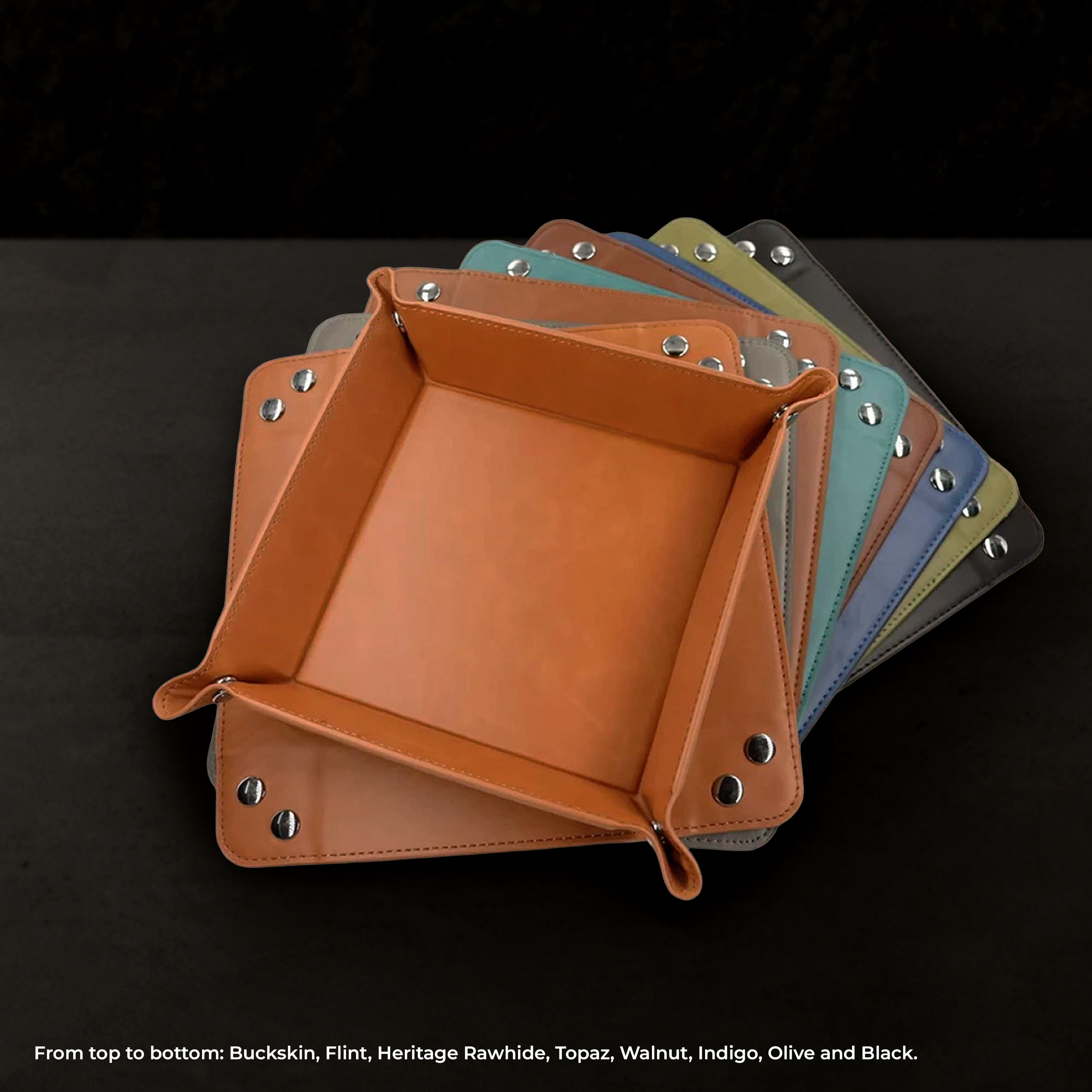 Set of leather valet trays in various colors on a black background