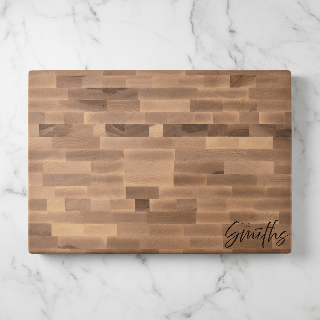 Wooden cutting board with 'The Smiths' engraving on a marble surface