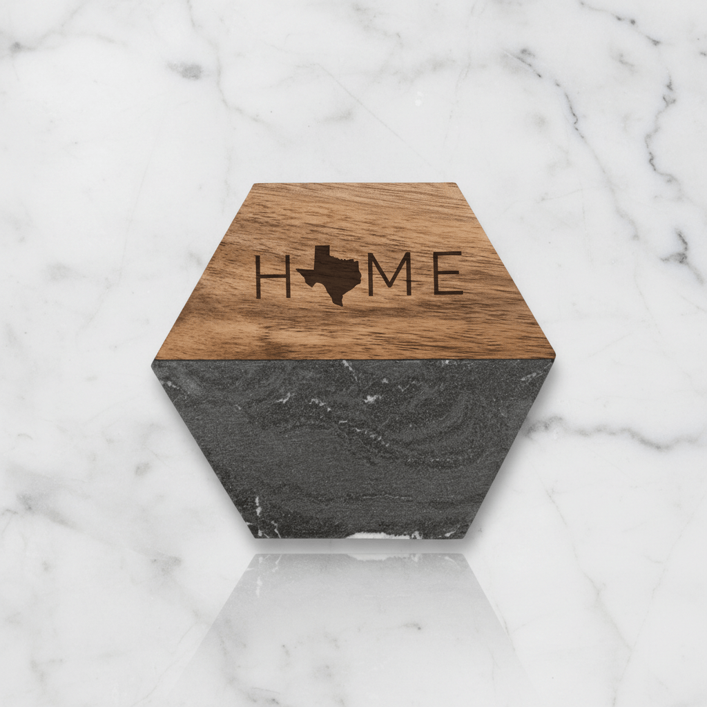 Hexagonal coaster with wooden top and black marble bottom on a marble surface