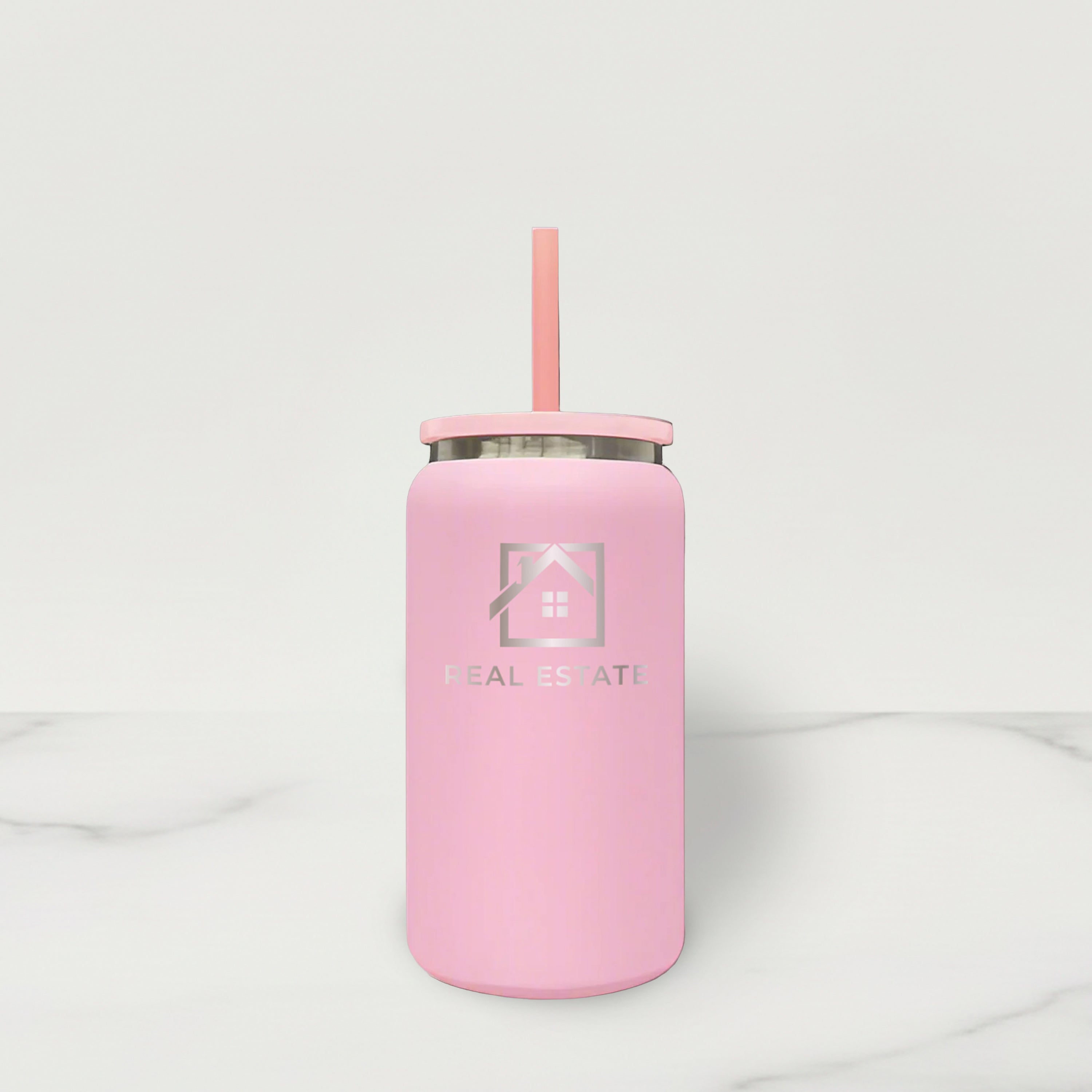 Pink tumbler with a straw on a white background