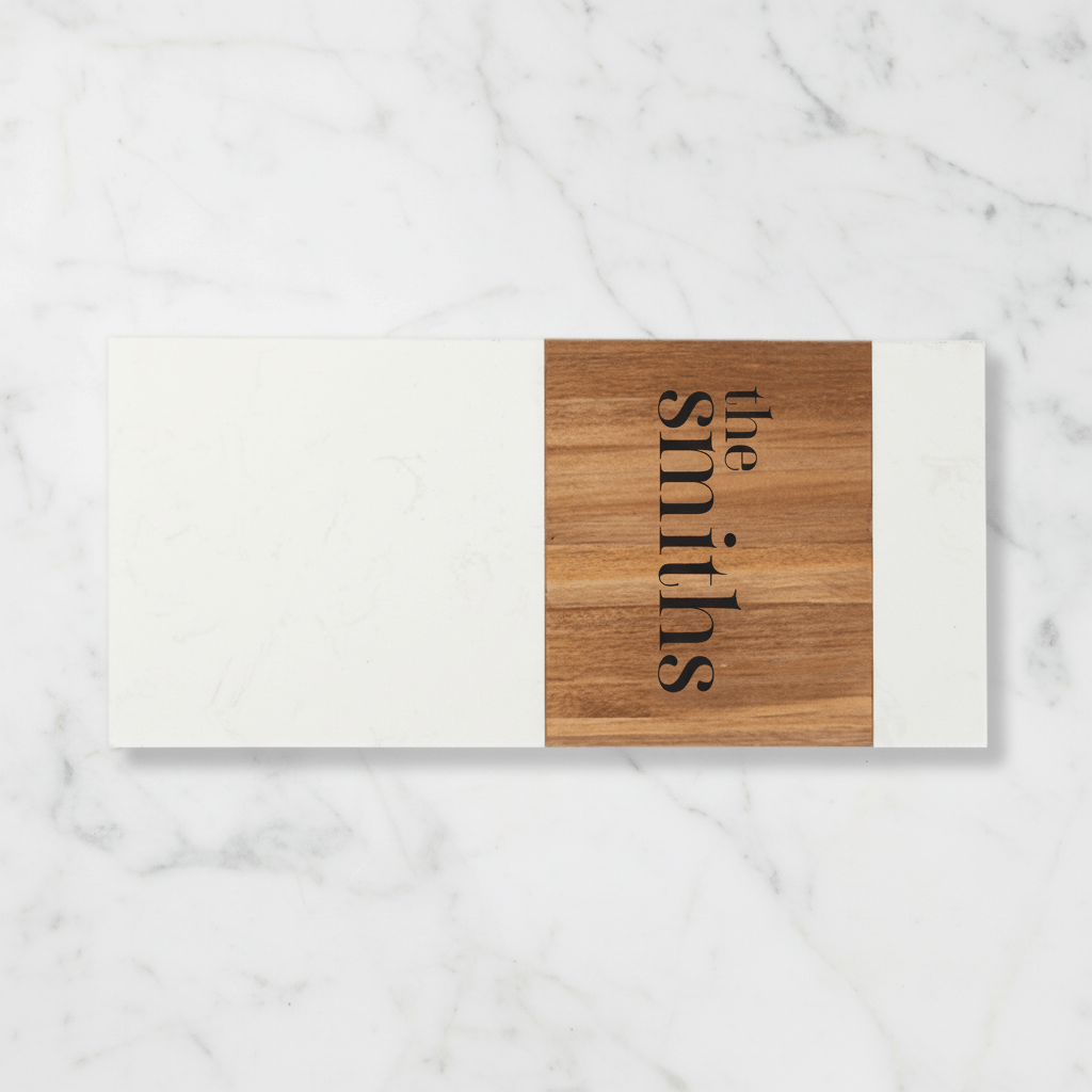 Wood and marble charcuterie board with 'the smiths' engraving on a marble surface