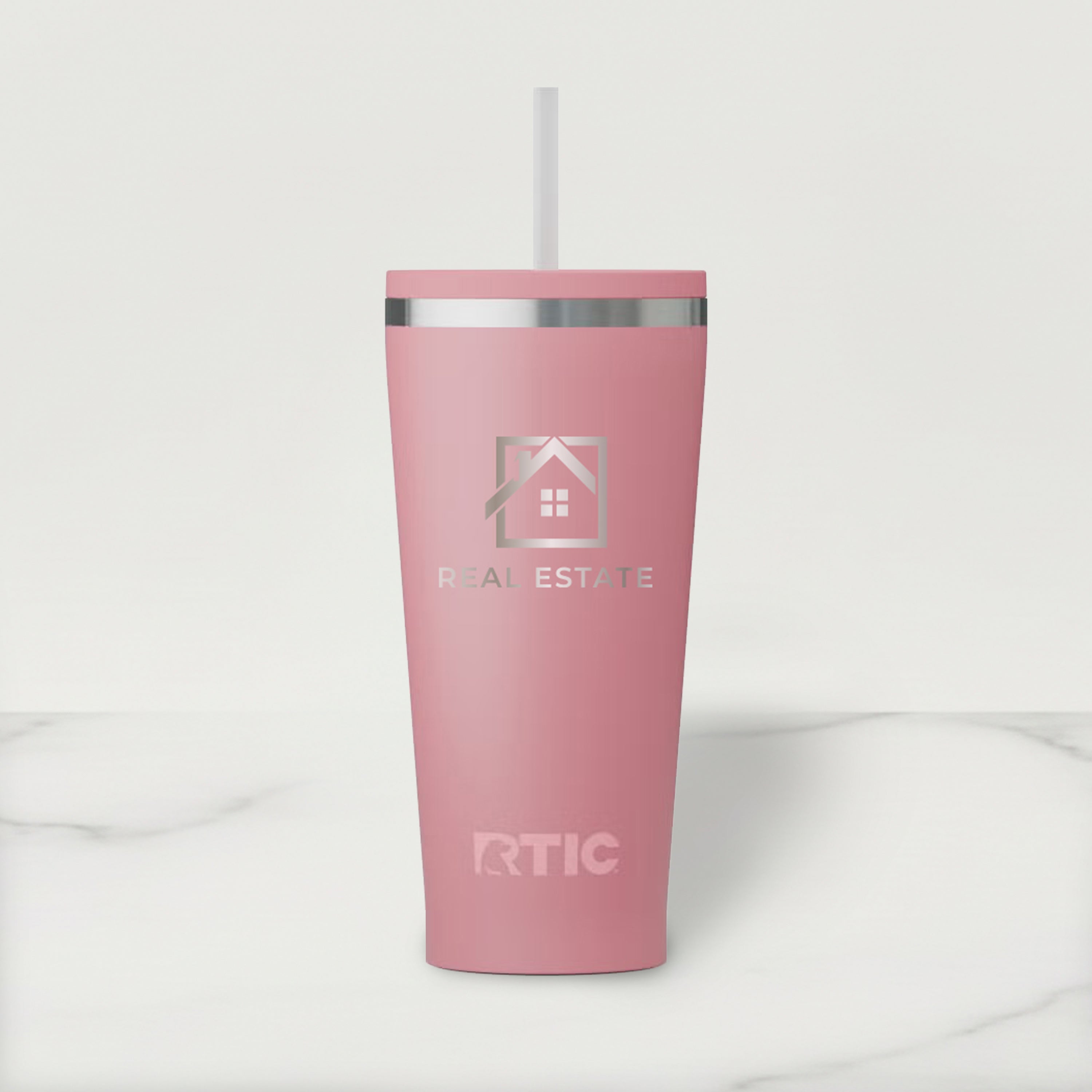 Pink RTIC tumbler with a straw on a white background