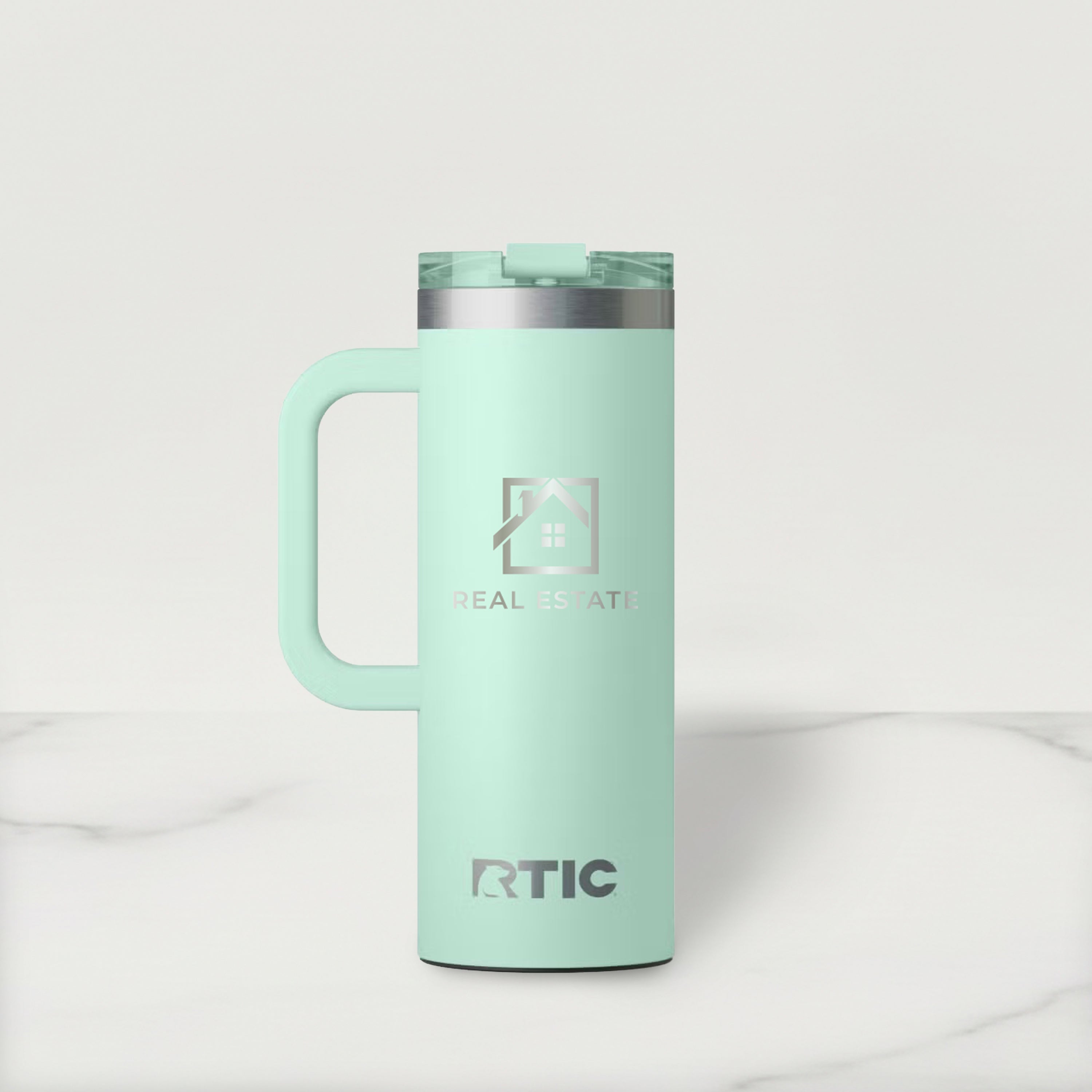 Mint green RTIC mug with handle on a light gray background