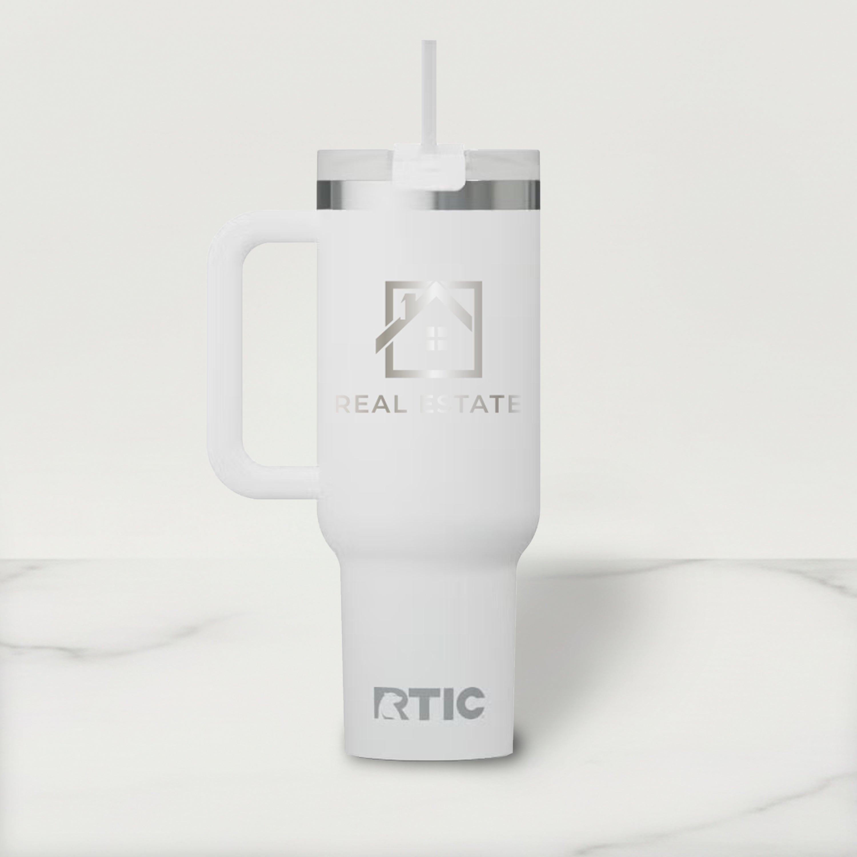White RTIC tumbler with a Real Estate logo on a light gray background