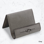 Gray business card holder with black engraving on a marble background