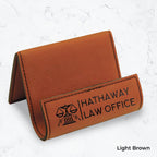 Brown business card holder with black engraving on a marble background