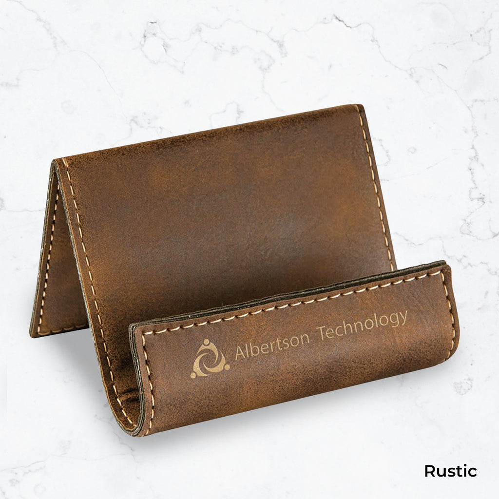 Brown business card holder with gold engraving on a marble background