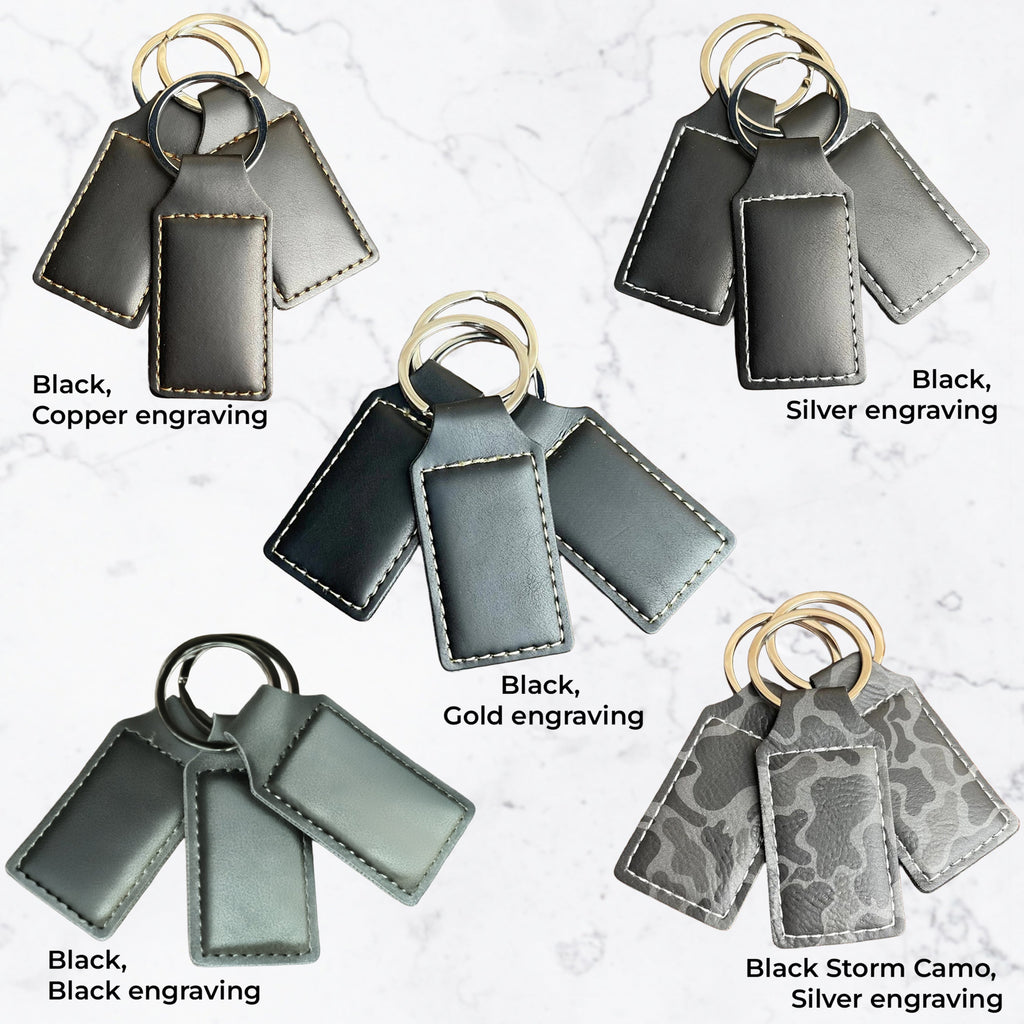 Different types of black keychains with different engraving colors on white background