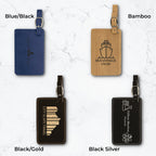 Four luggage tags in different colors and engravings on a white marble background.