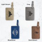 Four luggage tags in different colors and engravings on a white marble background.