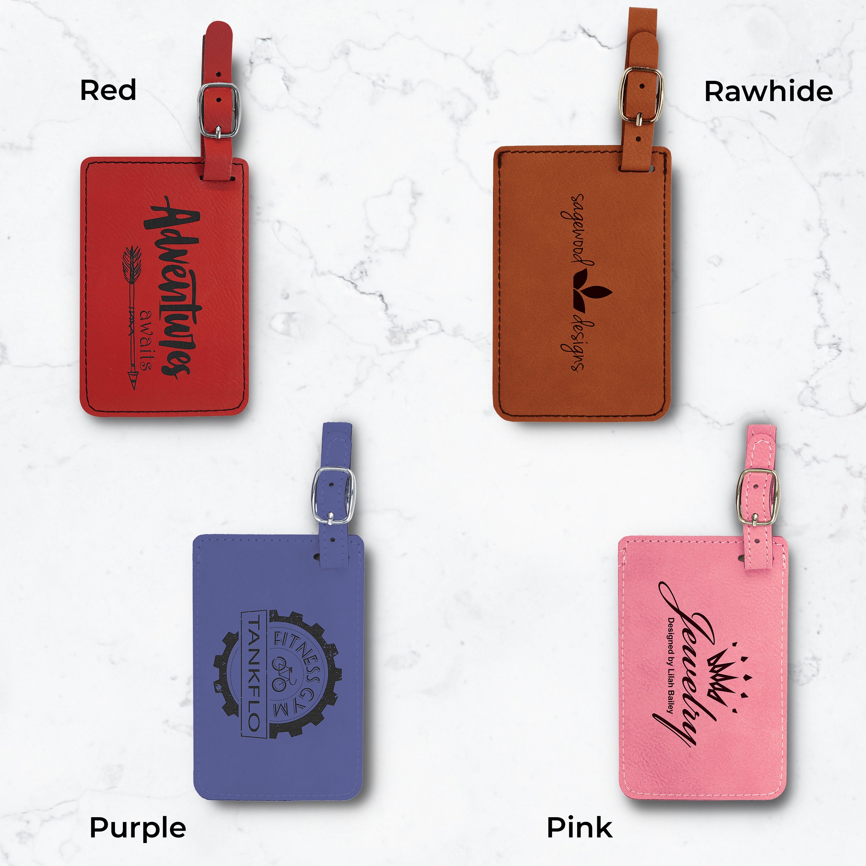 Four luggage tags in different colors and engravings on a white marble background.