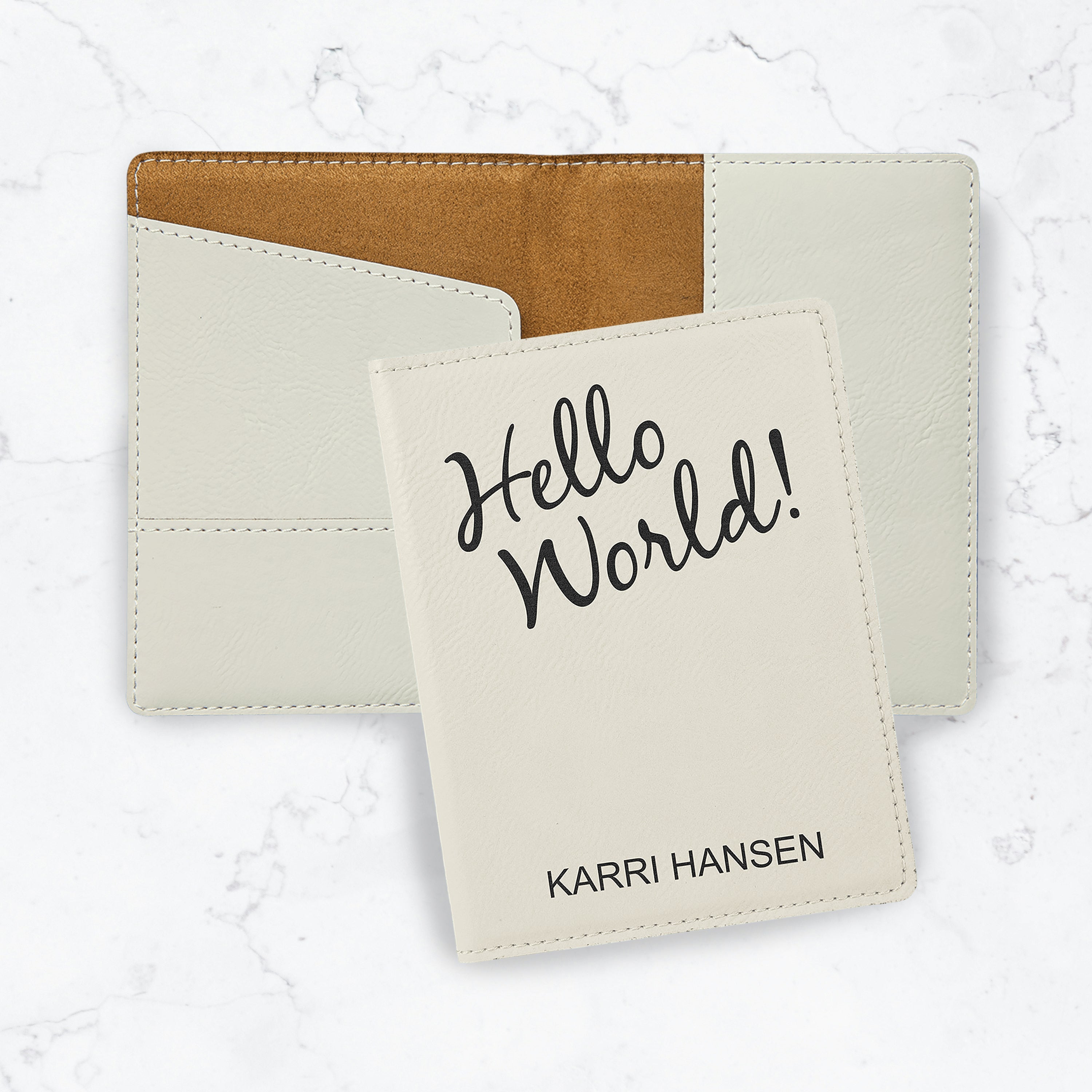 White passport cover with black engraving on white marble background