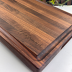 Wooden cutting board with engraved text on a white surface